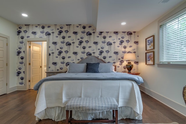 bedroom featuring wallpapered walls, wood finished floors, and baseboards