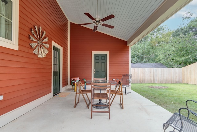 view of patio / terrace featuring a ceiling fan, outdoor dining space, and fence