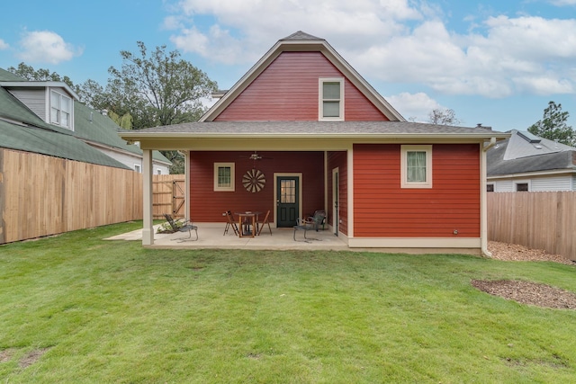 back of house featuring a lawn, a fenced backyard, a ceiling fan, and a patio area