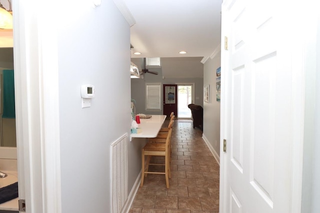 hall with recessed lighting, visible vents, and baseboards