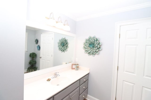 bathroom with vanity, baseboards, and ornamental molding