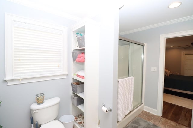 ensuite bathroom featuring baseboards, ensuite bath, a stall shower, ornamental molding, and toilet