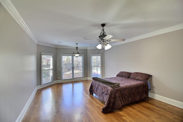 bedroom with multiple windows, baseboards, light wood-type flooring, and ornamental molding