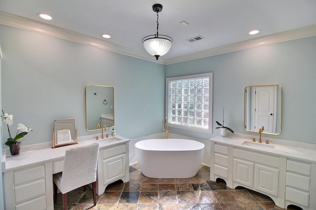 bathroom with visible vents, a freestanding bath, two vanities, and a sink