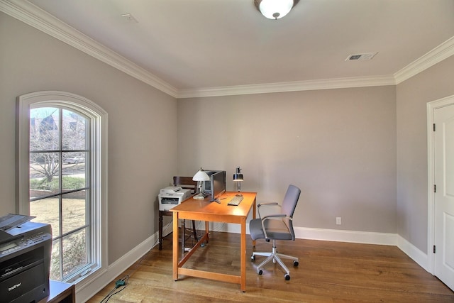 home office with visible vents, ornamental molding, baseboards, and wood finished floors