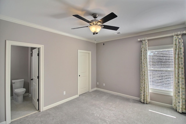 unfurnished bedroom featuring visible vents, carpet floors, baseboards, and ornamental molding