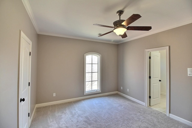 unfurnished room featuring visible vents, light carpet, ornamental molding, baseboards, and ceiling fan