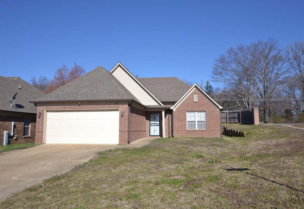 single story home with brick siding, a shingled roof, a front yard, a garage, and driveway