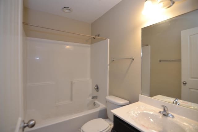 bathroom with tub / shower combination, toilet, and vanity