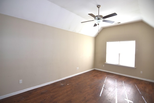 empty room with vaulted ceiling, wood finished floors, baseboards, and ceiling fan