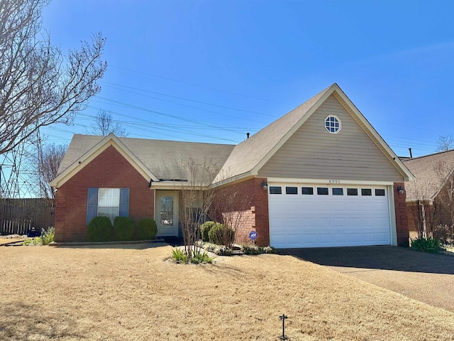 single story home featuring an attached garage, brick siding, and driveway