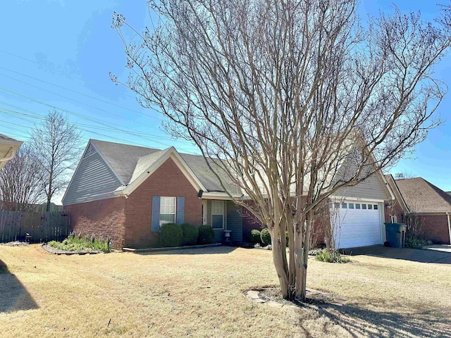 single story home featuring brick siding, an attached garage, a front lawn, and fence