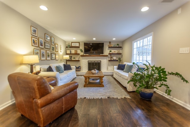 living area featuring a brick fireplace, recessed lighting, wood finished floors, and baseboards