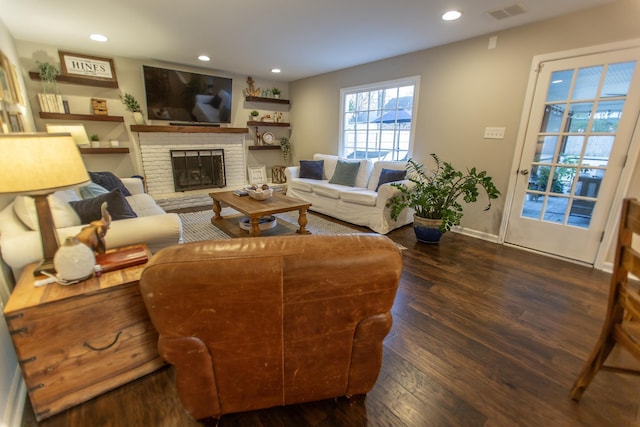 living room with visible vents, baseboards, recessed lighting, a fireplace, and dark wood-style floors