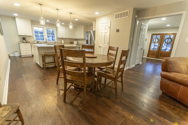 dining area with dark wood-style floors, visible vents, recessed lighting, and french doors