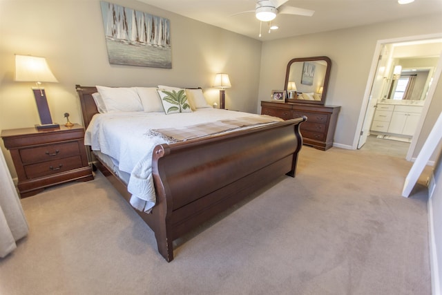 bedroom featuring light carpet, a ceiling fan, recessed lighting, connected bathroom, and baseboards