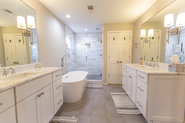 full bathroom featuring visible vents, two vanities, a sink, a closet, and a shower stall