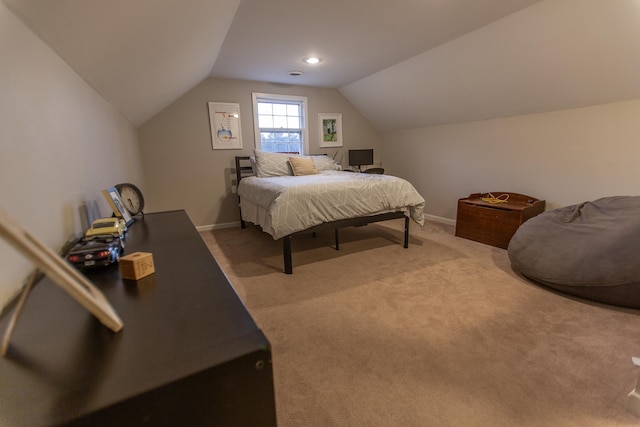 carpeted bedroom with baseboards and vaulted ceiling