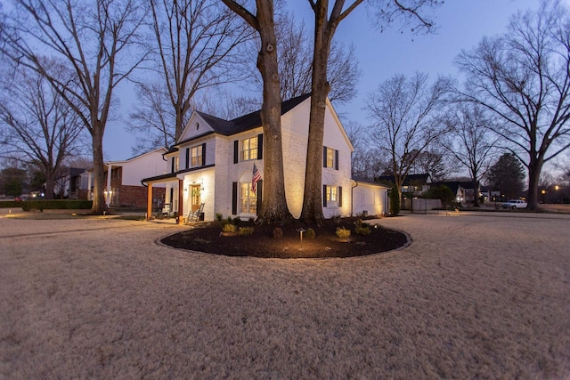 view of side of property featuring a garage and brick siding