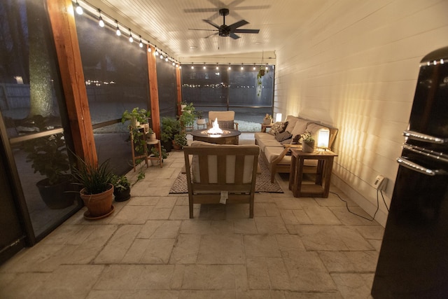 view of patio / terrace with an outdoor living space with a fire pit and ceiling fan