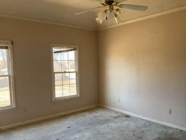 unfurnished room featuring plenty of natural light, ceiling fan, and ornamental molding