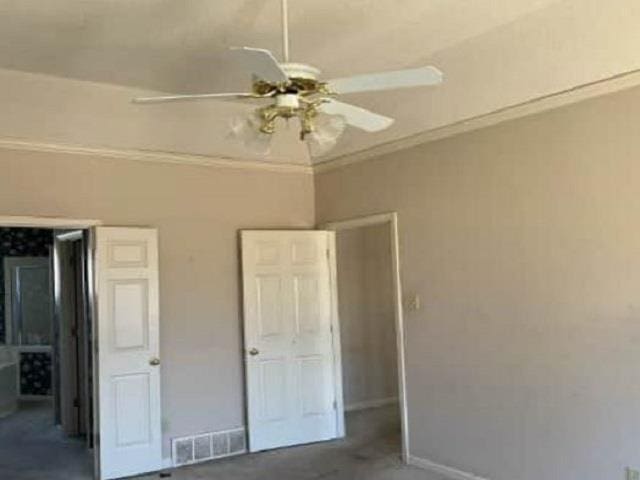 unfurnished bedroom with visible vents, baseboards, ceiling fan, and ornamental molding