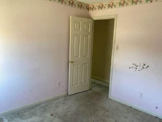 unfurnished room with concrete flooring