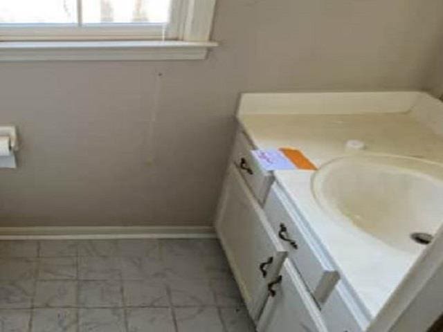 bathroom with baseboards and vanity