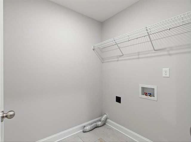 clothes washing area with electric dryer hookup, baseboards, washer hookup, and laundry area