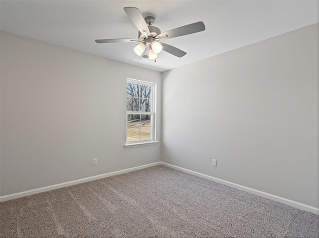 carpeted spare room with baseboards and ceiling fan