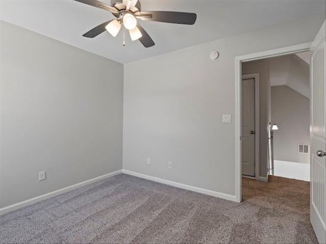 spare room with visible vents, baseboards, and carpet