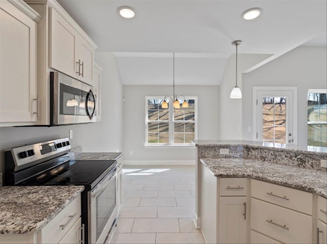 kitchen with vaulted ceiling, light tile patterned floors, light stone countertops, and stainless steel appliances