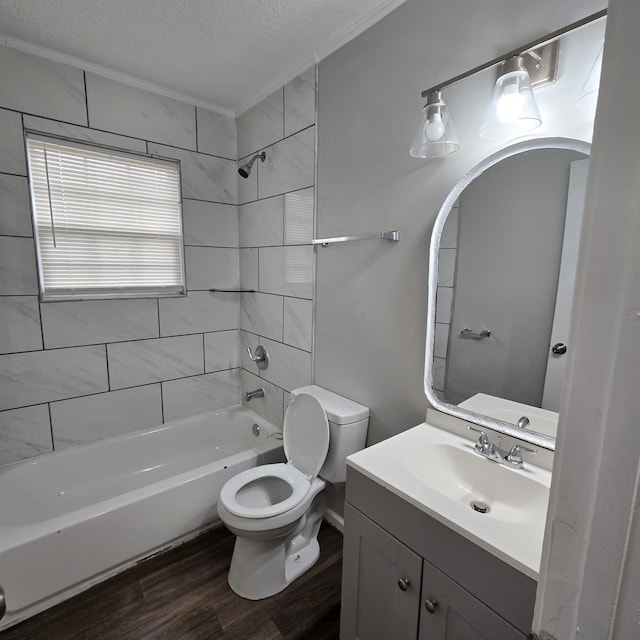 full bath with vanity, wood finished floors, bathtub / shower combination, a textured ceiling, and toilet