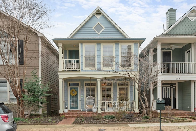 view of front of home with a balcony, a porch, and ceiling fan