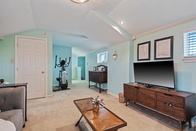 living room featuring lofted ceiling, light colored carpet, and baseboards