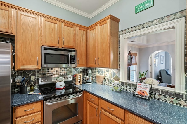 kitchen featuring dark stone countertops, tasteful backsplash, appliances with stainless steel finishes, and ornamental molding