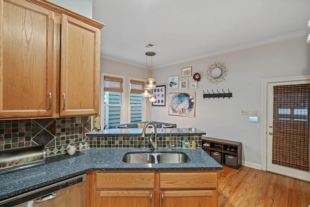 kitchen with visible vents, dishwasher, crown molding, and a sink