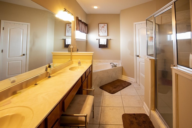 full bath with double vanity, a stall shower, a sink, tile patterned floors, and a bath