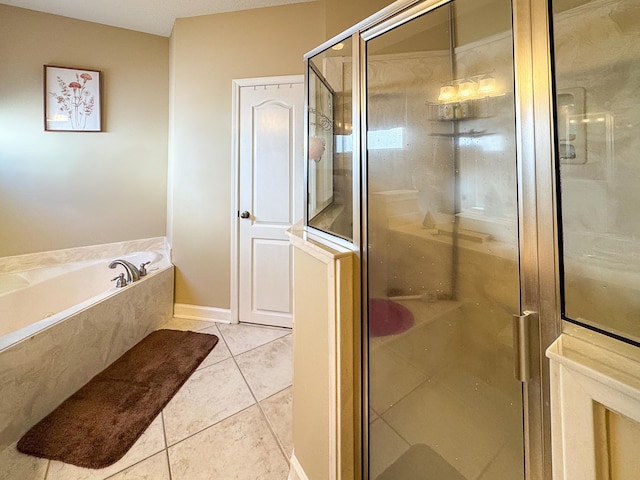 full bathroom featuring tile patterned floors, a garden tub, and a shower stall