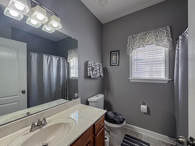 bathroom featuring vanity, a shower with curtain, baseboards, visible vents, and toilet