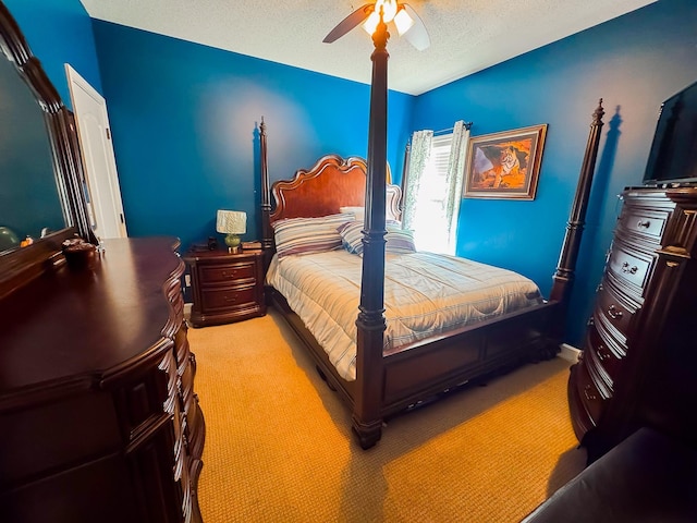 carpeted bedroom with a textured ceiling and ceiling fan