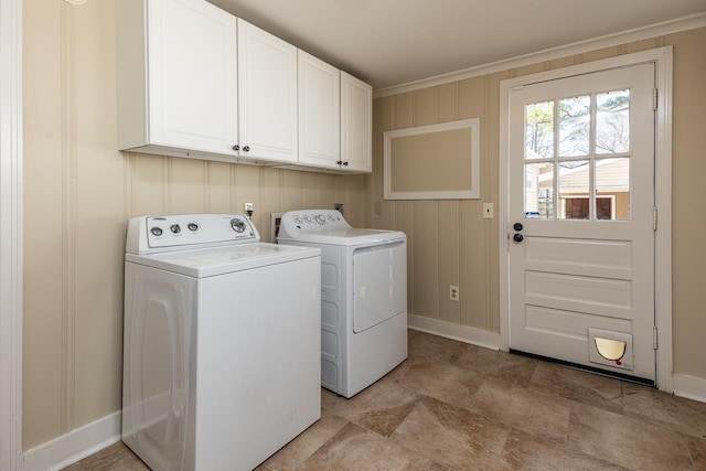 laundry room with cabinet space, baseboards, and separate washer and dryer