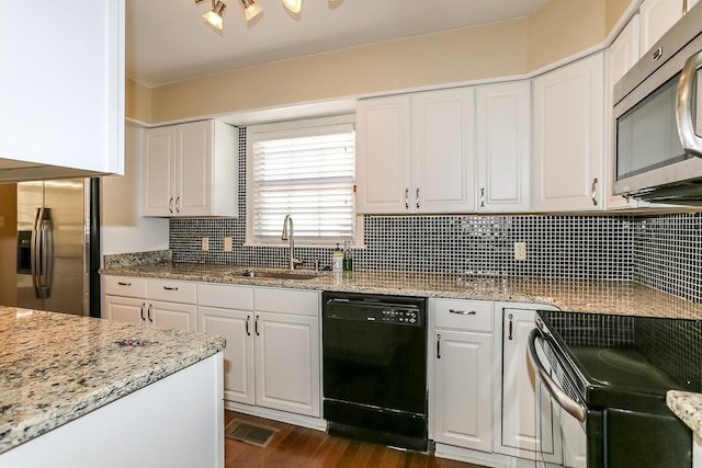 kitchen with black appliances, a sink, light stone counters, tasteful backsplash, and white cabinets