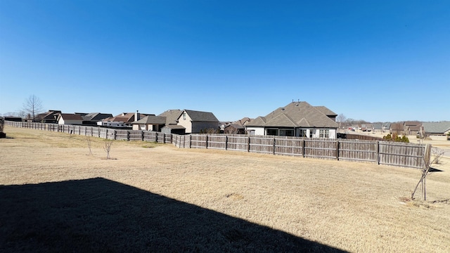 view of yard featuring a residential view and fence