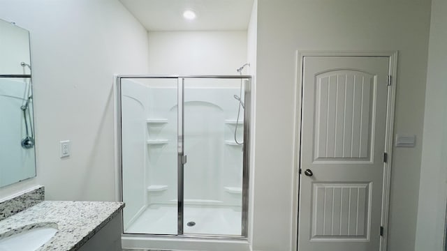 full bath featuring a shower stall and vanity