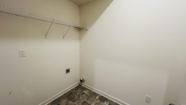 clothes washing area featuring electric dryer hookup, baseboards, and laundry area