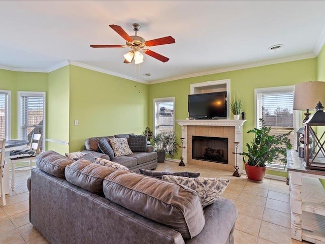 living room with light tile patterned flooring, visible vents, a tiled fireplace, and ornamental molding