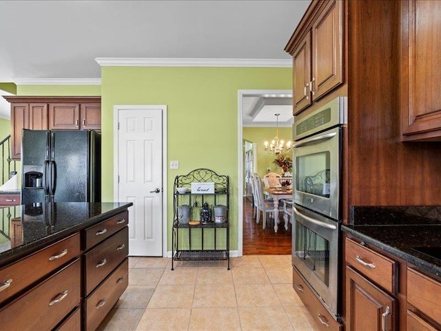 kitchen with light tile patterned floors, stainless steel double oven, ornamental molding, black refrigerator with ice dispenser, and a chandelier