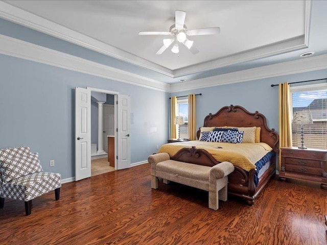 bedroom featuring a tray ceiling, crown molding, and wood finished floors