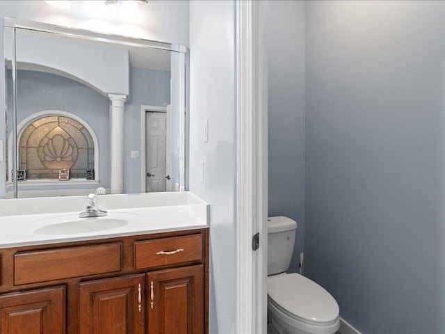 bathroom featuring toilet and vanity